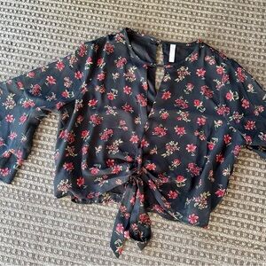Black crop top with bell sleeves, red floral print, and v-neck cutout